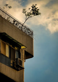 Low angle view of building against cloudy sky