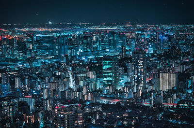 Illuminated modern buildings in city at night