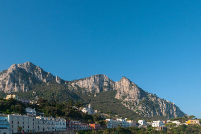 Scenic view of mountains against clear blue sky