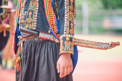 Low section of man with multi colored umbrella