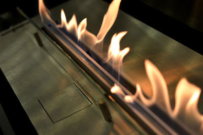 Close-up of burning candles in temple