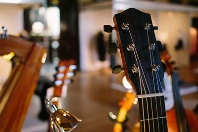 Close-up of guitars in shop for sale