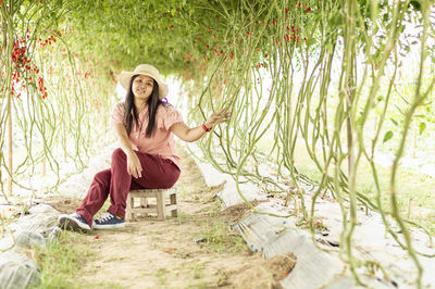 Portrait of young woman sitting outdoors