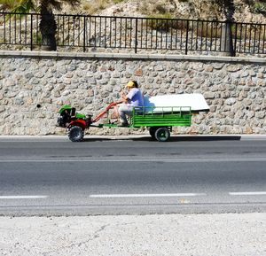 Full length of a man with bicycle on road