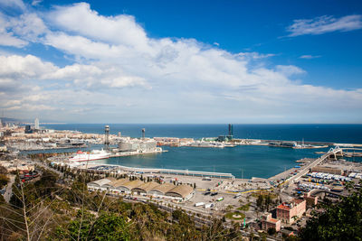 High angle view of townscape and sea against sky