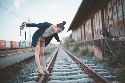 Man standing on railroad station platform