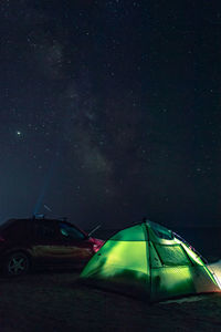 Tent on field against sky at night