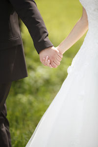 Midsection of bride holding hands