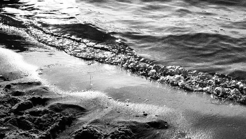 High angle view of waves rushing towards shore