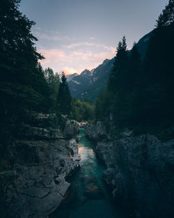 Scenic view of river amidst mountains against sky