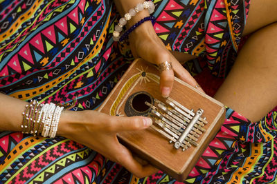 High angle view of woman playing musical instrument