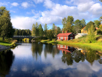 Scenic view of lake by building against sky