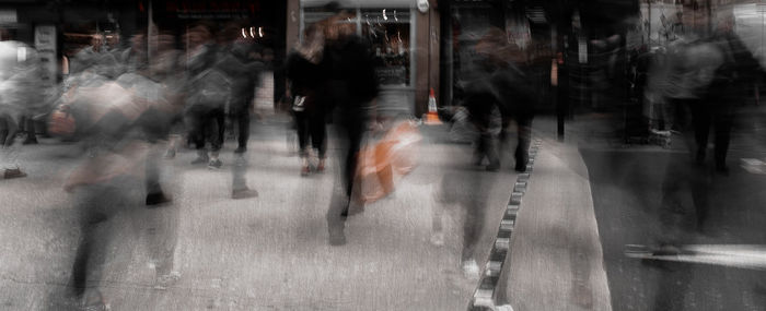 Group of people walking on city street