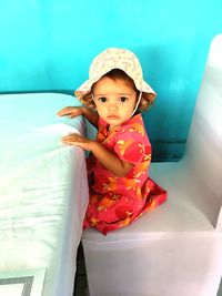 Cute baby girl sitting in hat