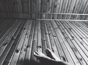Low section of person on wooden floor