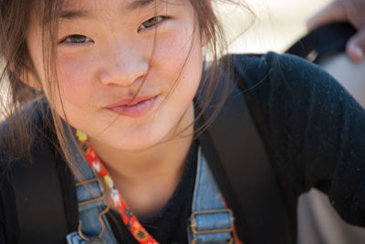 Close-up portrait of smiling pre-adolescent girl