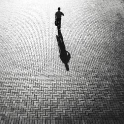 Shadow of man on street