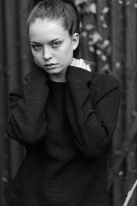 Close-up portrait of young woman standing outdoors