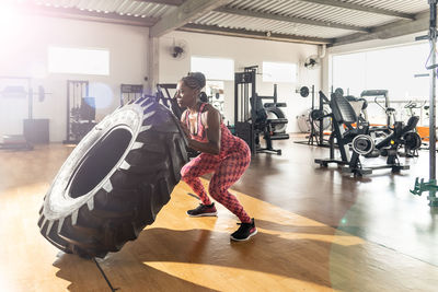 Side view of man standing in gym