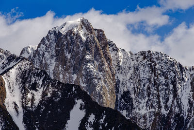 Low angle view of snowcapped mountain against sky