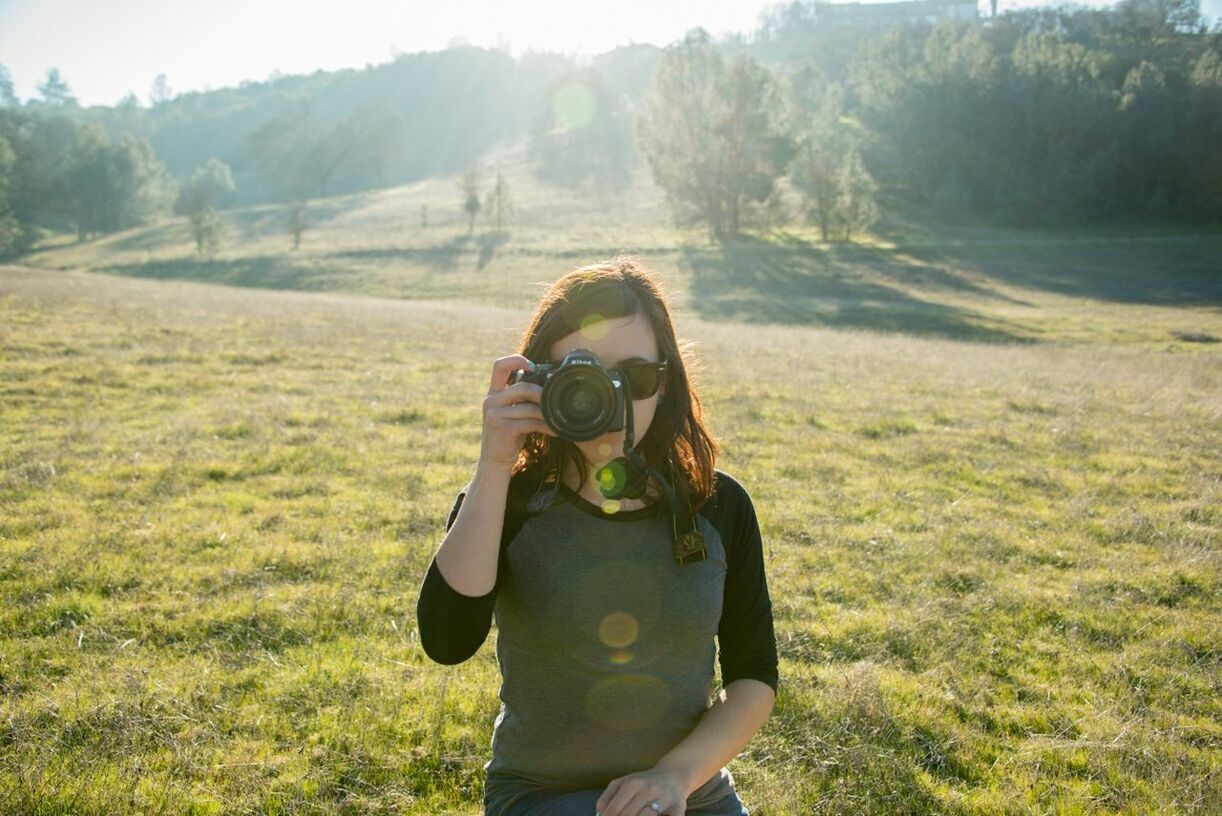 lifestyles, grass, young adult, leisure activity, casual clothing, person, field, young women, three quarter length, looking at camera, tree, grassy, standing, landscape, sunglasses, portrait, front view, nature