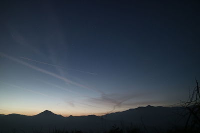 Scenic view of silhouette mountain against sky at night