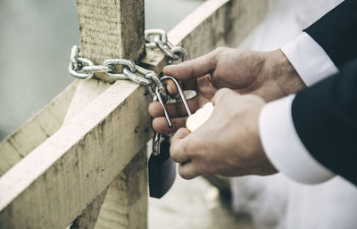 Cropped hands holding padlock