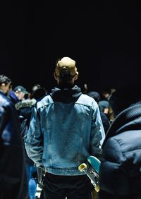 Rear view of people at sculpture at night