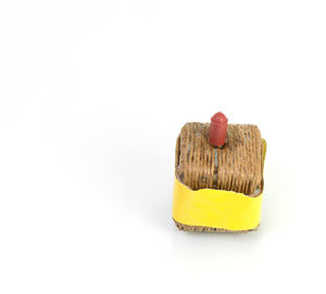 Close-up of yellow over white background