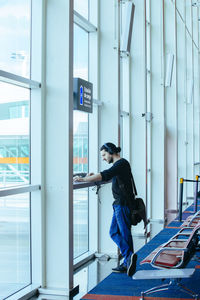 Side view of man working at window