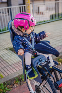 Rear view of girl riding bicycle