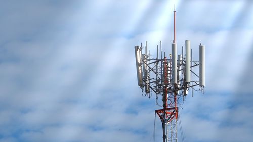 Low angle view of communications tower against sky