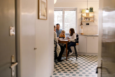 Family having meal together in kitchen at home