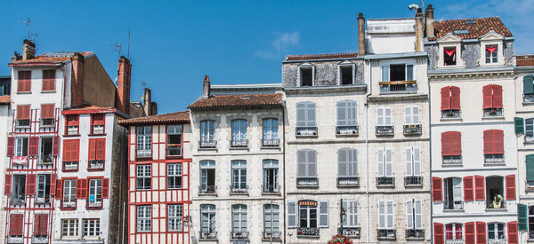 Low angle view of buildings in town against sky