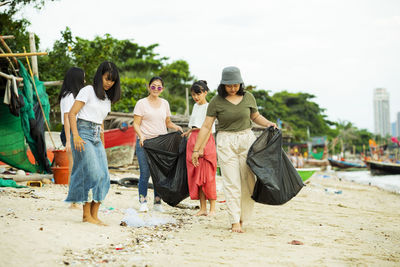 Females collecting garbage at beach
