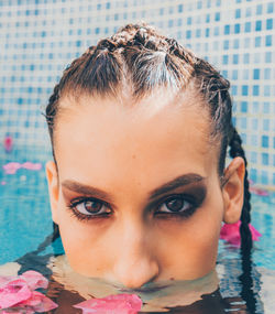 Close-up portrait of young woman in swimming pool