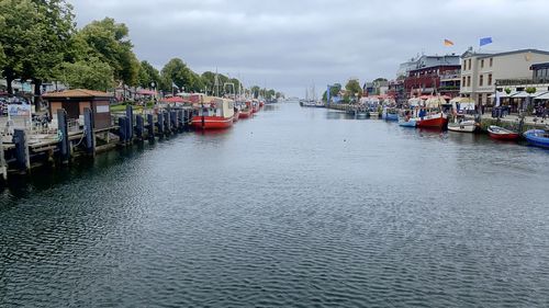 Scenic view of river against sky in city