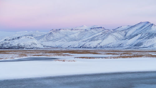 Snowcapped mountains against sky during winter