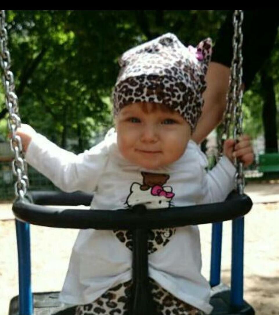 PORTRAIT OF A SMILING GIRL PLAYING