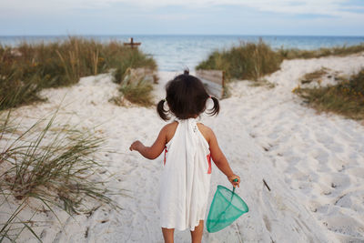 Rear view of girl at sea