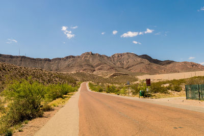 Empty road along countryside landscape