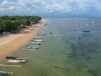 High angle view of sailboats moored on sea against sky