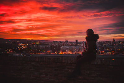 Silhouette cityscape against sky during sunset