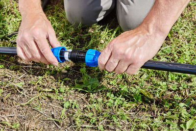 Low section of man working on field