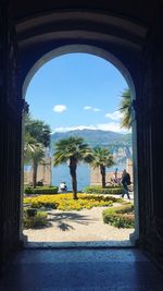 Woman seen through archway