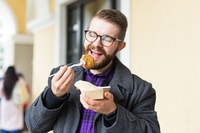 Portrait of young man holding ice cream