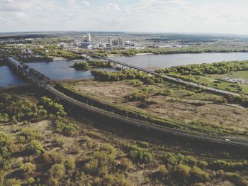 High angle view of river amidst city against sky