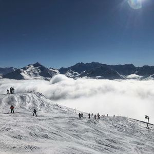 High angle view of people skiing on snowy landscape 