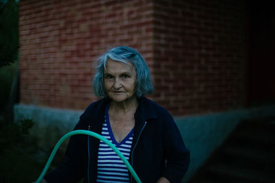 Portrait of a woman against wall
