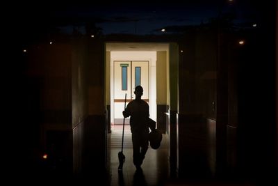 Hospital cleaner walking at passage